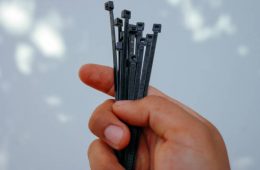 holding black cable tie