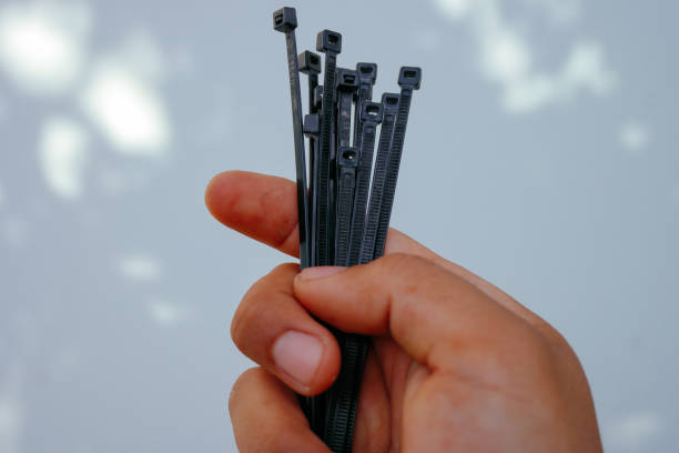 holding black cable tie