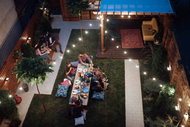 Top view of a Multi-ethnic friends enjoying dinner party at yard