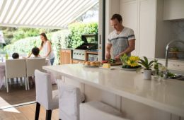 Family preparing lunch. Family preparing grill. Family have lunch on terrace.
